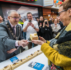 Burgemeester Aboutaleb reikt een stuk taart uit